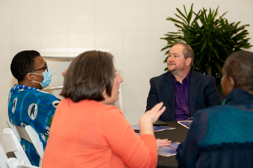 A group of people sitting around a table.