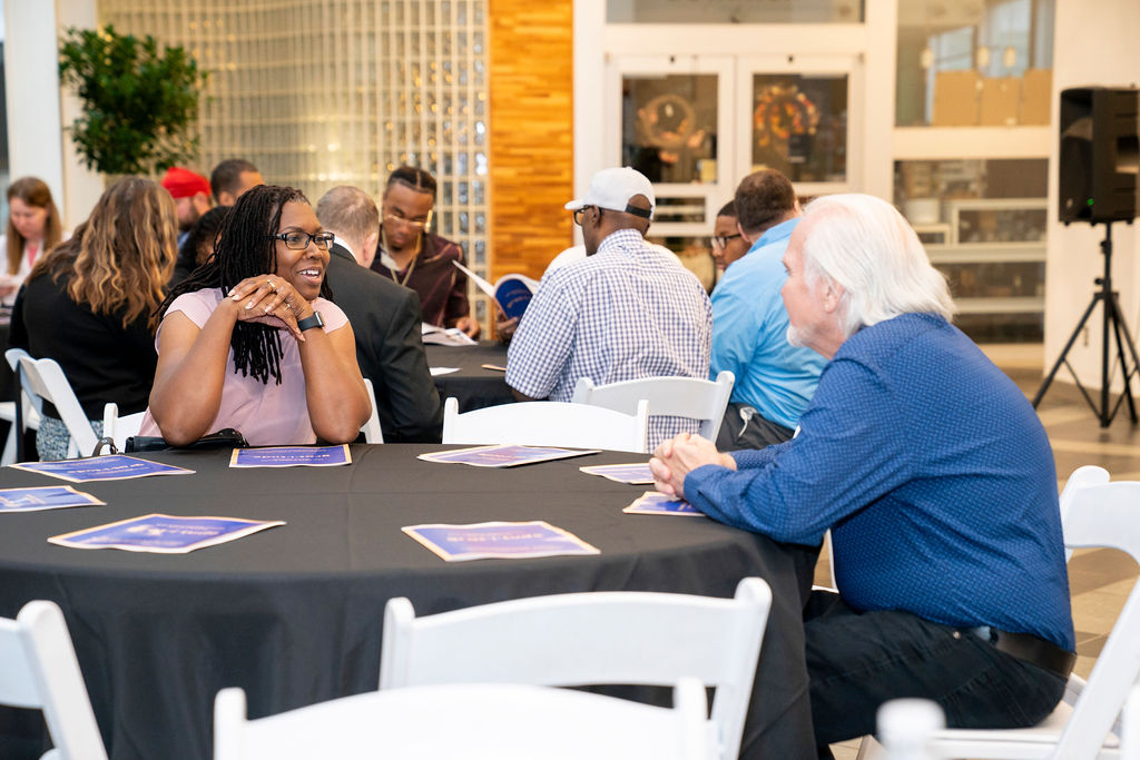 A group of people sitting around a table.