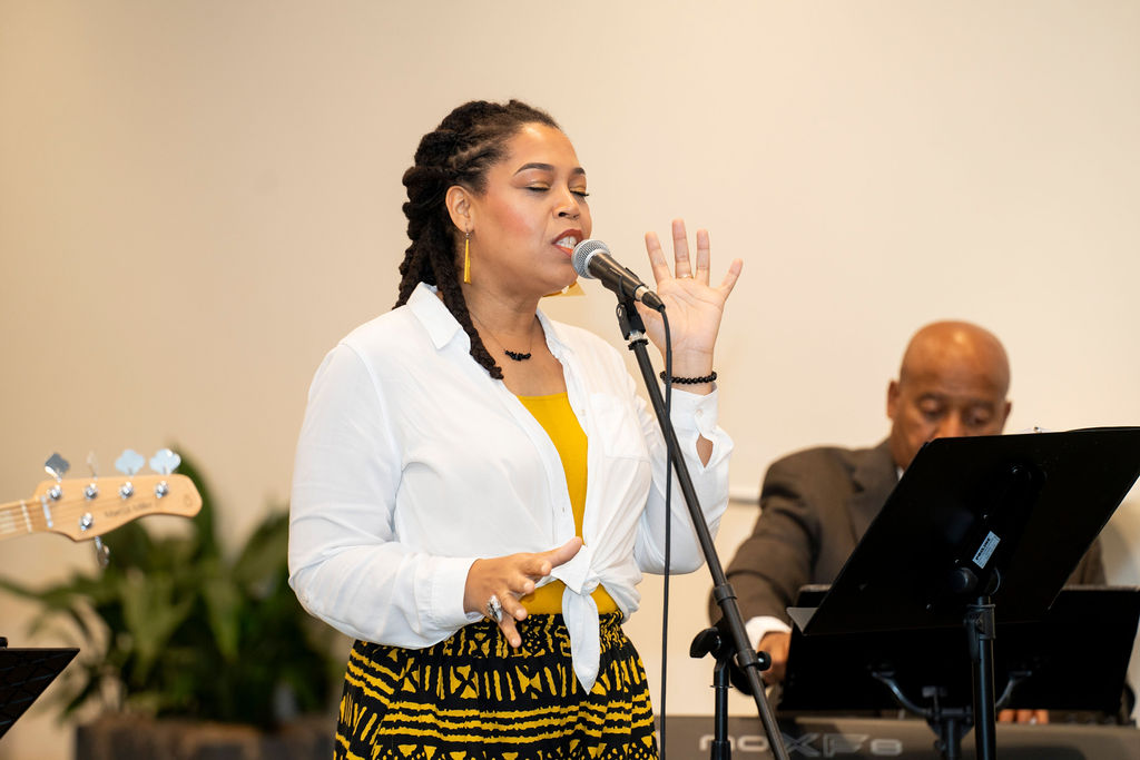 A woman is singing into a microphone